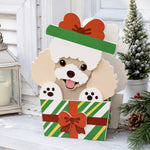 Christmas Poodle dog planter filled with fresh flowers is placed in the garden