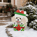 Christmas Poodle dog planter filled with fresh flowers is placed in the garden