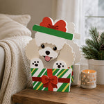 Christmas Poodle dog planter filled with fresh flowers is placed in the garden