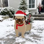 Christmas Pug dog planter filled with fresh flowers is placed in the garden