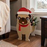 Christmas Pug dog planter filled with fresh flowers is placed in the garden