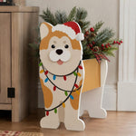 Christmas Shiba Inu dog planter filled with fresh flowers is placed in the garden
