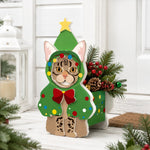 Christmas Tabby Cat planter filled with fresh flowers is placed in the garden