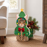 Christmas Tabby Cat planter filled with fresh flowers is placed in the garden