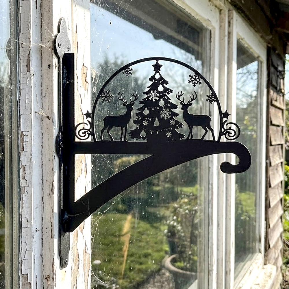 Christmas tree and reindeer metal hanging basket bracket mounted on outdoor wall for plant decoration