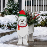 Christmas White Terrier dog planter filled with fresh flowers is placed in the garden