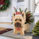 Christmas Yorkshire Terrier dog planter filled with fresh flowers is placed in the garden