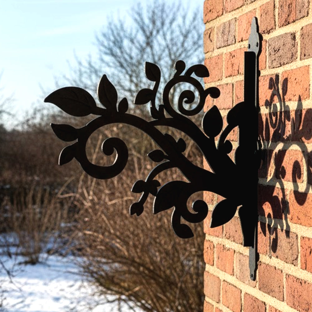 Classic scrollwork vines and leaves metal hanging basket bracket mounted on outdoor wall for plant decoration