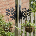 Classic scrollwork vines and leaves metal hanging basket bracket mounted on outdoor wall for plant decoration