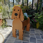 Cocker Spaniel dog planter filled with fresh flowers is placed in the garden