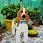 Cocker Spaniel dog planter filled with fresh flowers is placed in the garden