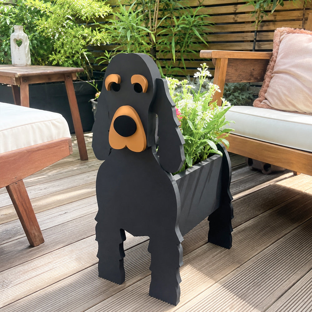 Cocker Spaniel dog planter filled with fresh flowers is placed in the garden