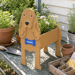 Cocker Spaniel dog planter filled with fresh flowers is placed in the garden