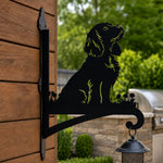 Cocker spaniel metal hanging basket bracket mounted on outdoor wall for plant decoration