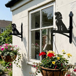 Cocker spaniel metal hanging basket bracket mounted on outdoor wall for plant decoration
