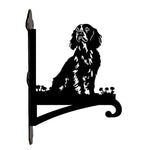 Cocker spaniel metal hanging basket bracket mounted on outdoor wall for plant decoration