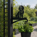 Cocker spaniel metal hanging basket bracket mounted on outdoor wall for plant decoration