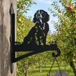 Cocker spaniel metal hanging basket bracket mounted on outdoor wall for plant decoration