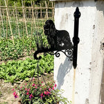 Cocker spaniel metal hanging basket bracket mounted on outdoor wall for plant decoration