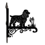 Cocker spaniel metal hanging basket bracket mounted on outdoor wall for plant decoration
