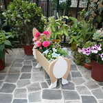 Corgi dog planter filled with fresh flowers is placed in the garden