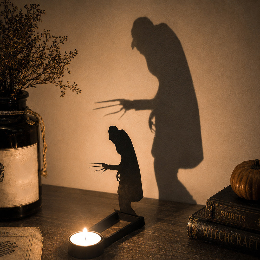 Creeping zombie halloween metal candle holder casting a spooky shadow on the wall