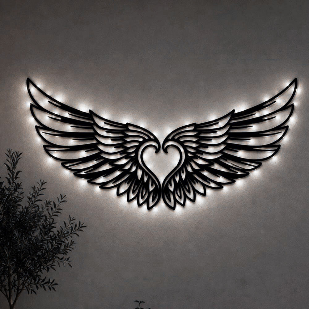 Black metal Cupid Heart wings wall art with Soft White LED Lighting displayed on the wall