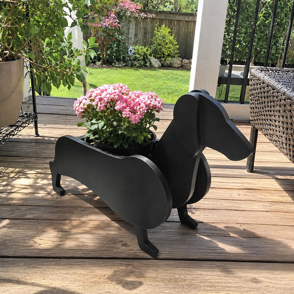 Dachshund dog planter filled with fresh flowers is placed in the garden