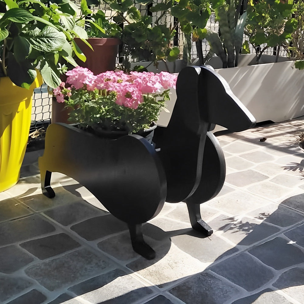 Dachshund dog planter filled with fresh flowers is placed in the garden