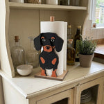 Dachshund Wooden Dog Paper Towel Holder displayed on a kitchen countertop with a freestanding paper towel roll