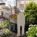 Devon Rex cat planter filled with fresh flowers is placed in the garden
