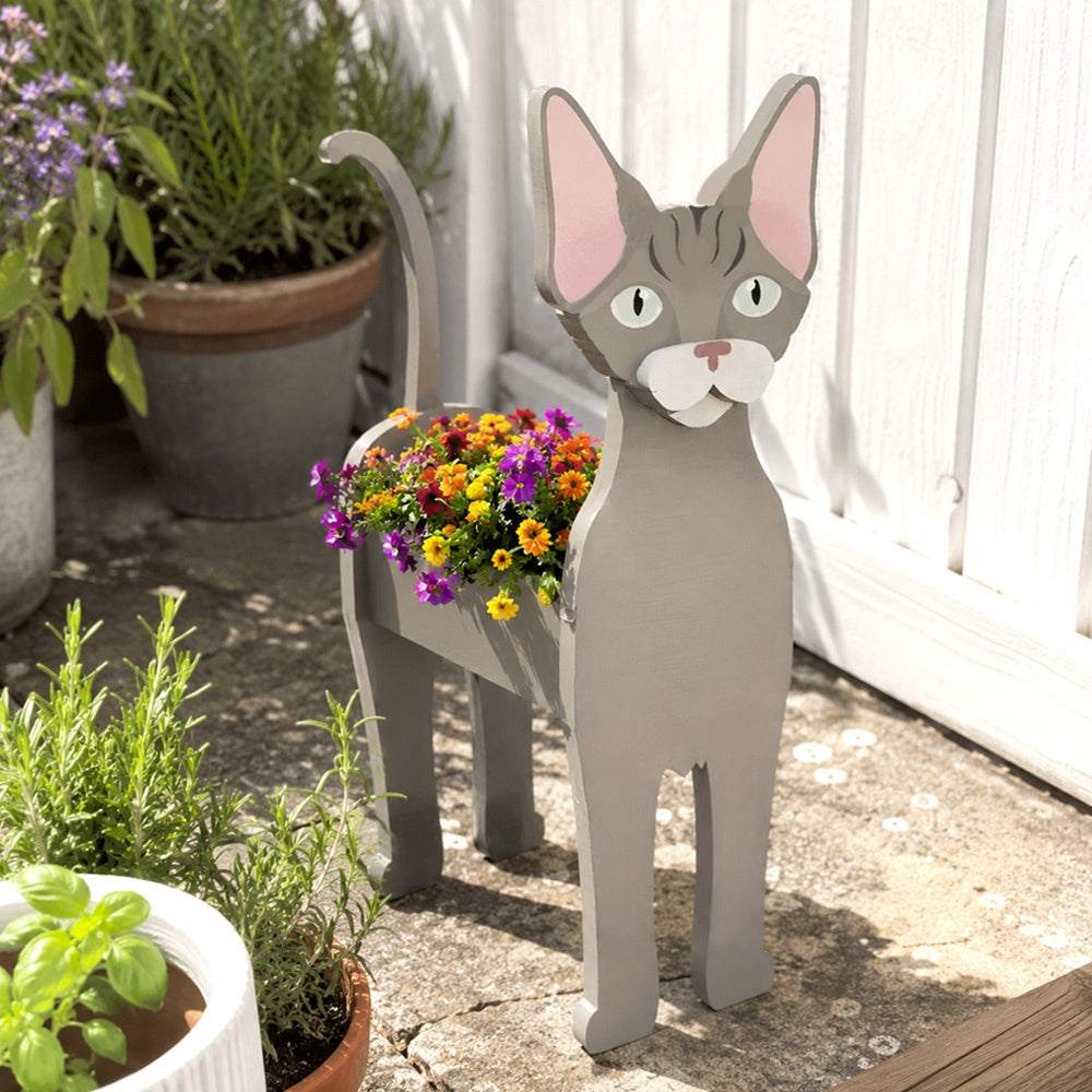 Devon Rex cat planter filled with fresh flowers is placed in the garden