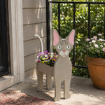 Devon Rex cat planter filled with fresh flowers is placed in the garden