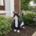 Devon Rex cat planter filled with fresh flowers is placed in the garden