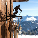 Downhill skier metal hanging basket bracket mounted on outdoor wall for plant decoration