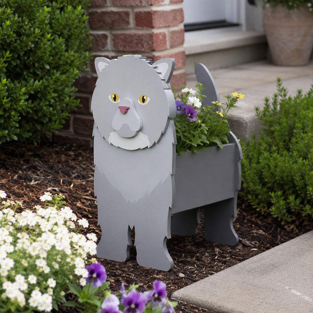 Exotic Shorthair cat planter filled with fresh flowers is placed in the garden