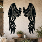 Black metal Fallen Angel wings wall art with intricate cutout details displayed on the wall