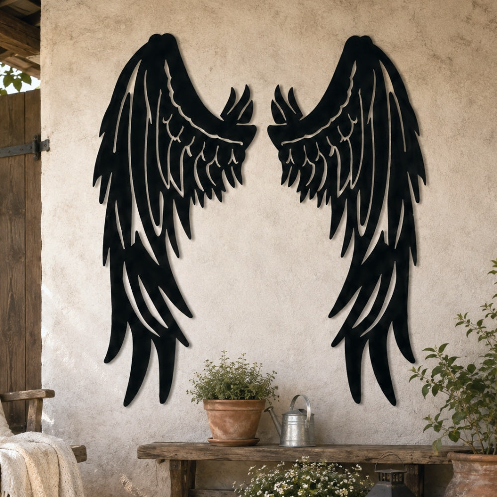 Black metal Fallen Angel wings wall art with intricate cutout details displayed on the wall