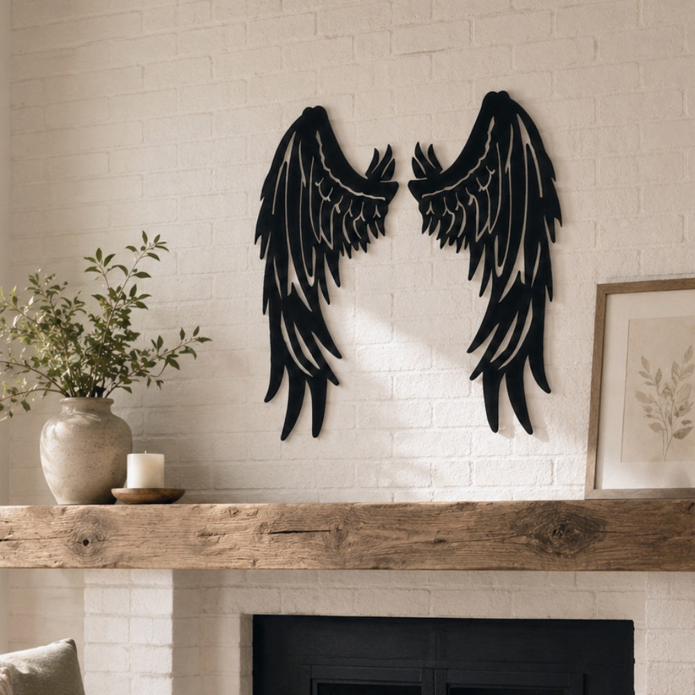 Black metal Fallen Angel wings wall art with intricate cutout details displayed on the wall