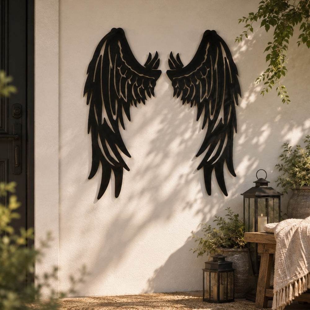 Black metal Fallen Angel wings wall art with intricate cutout details displayed on the wall