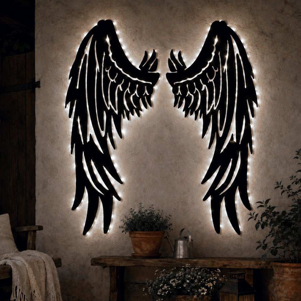 Black metal Fallen Angel wings wall art with Soft White LED Lighting displayed on the wall