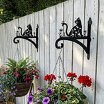 Floral cat and butterfly metal hanging basket bracket mounted on outdoor wall for plant decoration