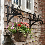 Floral cat and butterfly metal hanging basket bracket mounted on outdoor wall for plant decoration