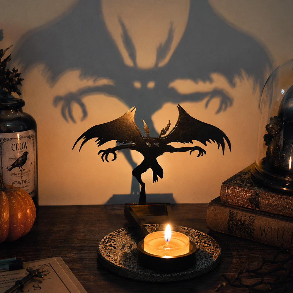 Flying dragon halloween metal candle holder casting a spooky shadow on the wall