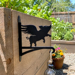 Flying pig metal hanging basket bracket mounted on outdoor wall for plant decoration