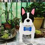 French Bulldog planter filled with fresh flowers is placed in the garden.
