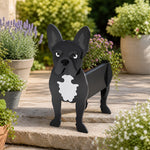 French Bulldog planter filled with fresh flowers is placed in the garden.