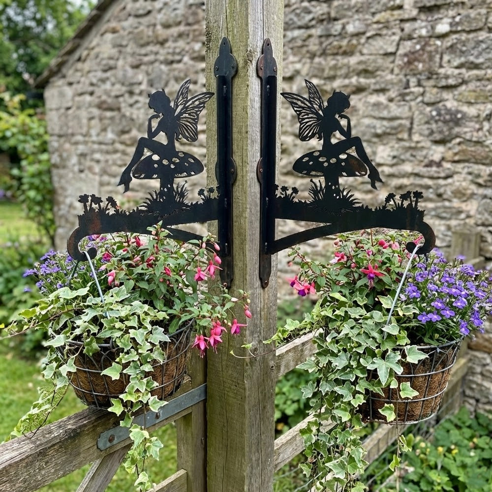 Garden fairy sitting on mushroom metal hanging basket bracket mounted on outdoor wall for plant decoration
