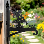 Garden fairy sitting on mushroom metal hanging basket bracket mounted on outdoor wall for plant decoration