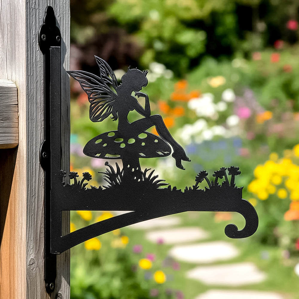 Garden fairy sitting on mushroom metal hanging basket bracket mounted on outdoor wall for plant decoration